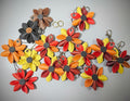 Colorful flower-shaped keychains on a dark surface