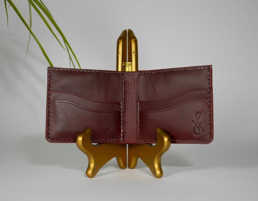 Brown leather wallet on a gold stand with a blurred background