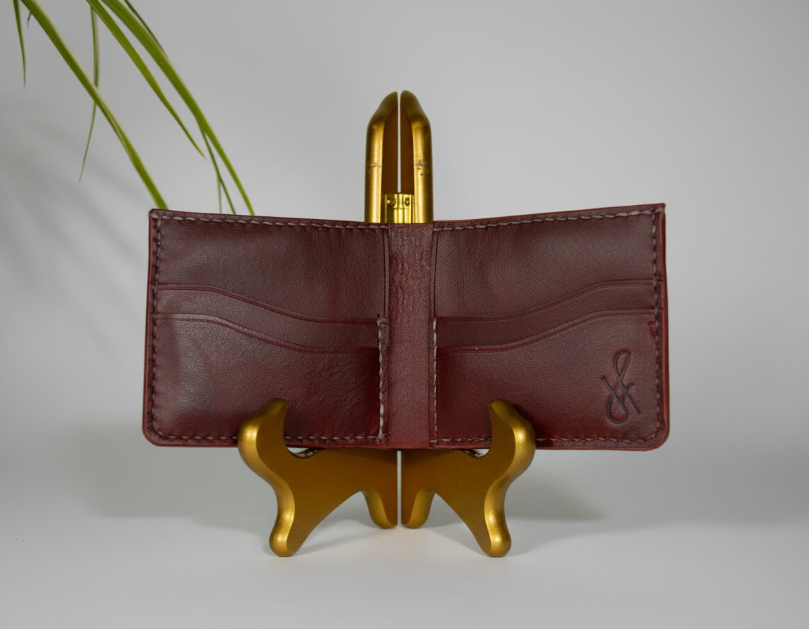 Brown leather wallet on a gold stand with a blurred background